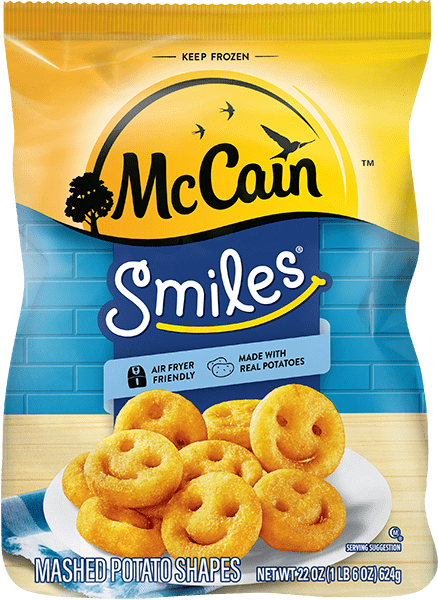 McCain Smiles product shot featuring hot and golden brown smiley fries called mashed potato shapes arrayed on a plate